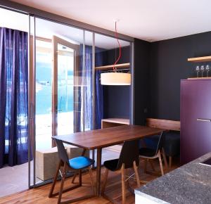 a dining room with a wooden table and chairs at Chalet Park Apartment mit Sauna Hamam in Diemtigen