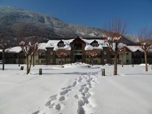 a snow covered building with footprints in the snow at Village Club Les Balcons des Pyrénées in Saint-Mamet