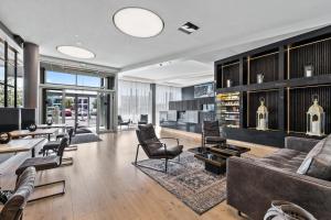 a living room with a couch and chairs and tables at Hotel Ísland – Spa & Wellness Hotel in Reykjavík