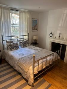 a large bed in a bedroom with a fireplace at 2bed house in Vauxhall in London