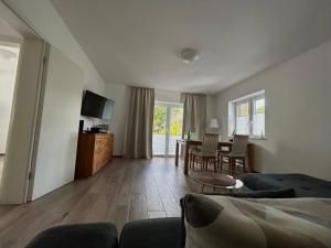a living room with a couch and a table at Ferienwohnung Kader 2 in Eckernförde
