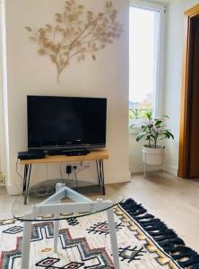 sala de estar con mesa y TV en Lovely port apártement, en San Sebastián