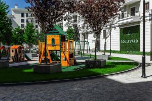 a park with a playground in a city at Boulevard 181 in Tashkent