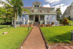 a house with a brick walkway in front of it at Pestana Vila Lido Madeira Ocean Hotel in Funchal