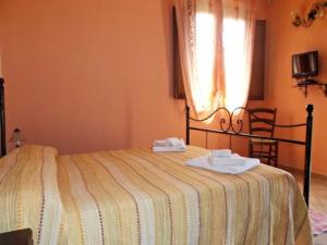 A bed or beds in a room at Agriturismo S´Aranada