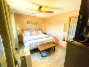 a bedroom with a bed and a ceiling fan at The Loft inside The Roost in Jordan