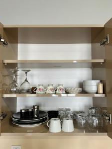 a kitchen shelf with plates and dishes on it at BUREAU RESİDENCE STÜDYO DAİRE in Kartepe