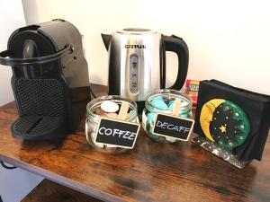 a table with a coffeemaker and cups and a coffee maker at Casa Aurelia in Rome