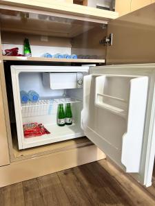 an open refrigerator with two bottles of beer in it at BUREAU RESİDENCE STÜDYO DAİRE in Kartepe