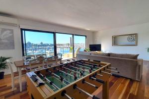 a living room with a foos ball in a table at Marina Magic Getaways - Your Waterfront Retreat in Patterson Lakes