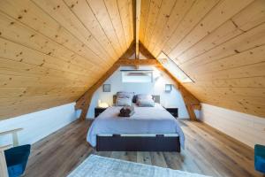 a cat laying on a bed in a wooden room at Havre de paix proche de la mer, pointe de Pors Pin in Plouézec