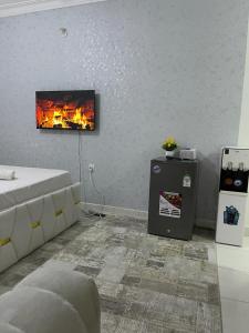 a living room with a fireplace and a bed and a table at Chillhaushomes in Mombasa
