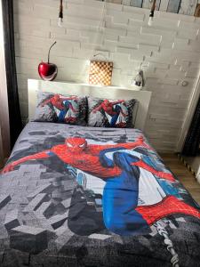a bedroom with a spiderman blanket on a bed at Cosy apartment Disneyland Paris en face de la gare RER val d'Europe in Serris