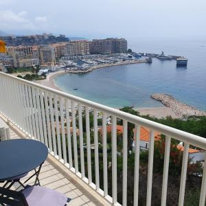 a balcony with a view of a beach and the ocean at BRIDGESTREET MONACO - cap d ail - roquebrune in Saint-Antoine