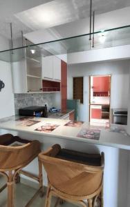 a kitchen with two chairs and a counter top at Likas Square Cozy Family 3 bedrooms - Keysuites in Kota Kinabalu