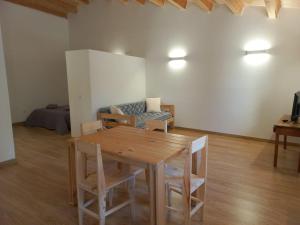a living room with a wooden table and a couch at Cal Vallverdú 2D in Preixana +13 photos