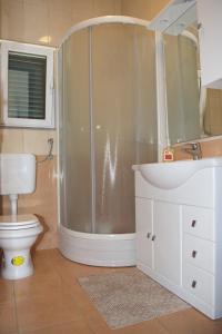 a bathroom with a shower and a toilet and a sink at Villa Srima in Vodice