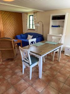 a living room with a wooden table and chairs at Ferienhaus Mangels in Steinau