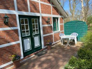 a patio with a table and chairs on a brick house at Ferienhaus Mangels in Steinau