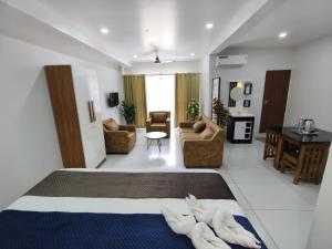 a bedroom with a bed and a living room at Wayanad Palace in Ambalavayal