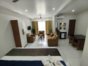 a bedroom with a bed and a living room at Wayanad Palace in Ambalavayal