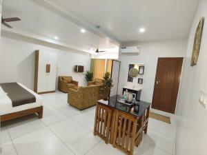 a hotel room with a bed and a living room at Wayanad Palace in Ambalavayal +29 photos