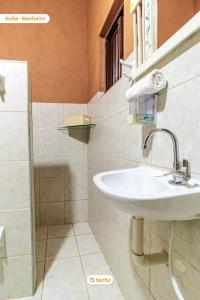 a bathroom with a sink and a shower at Pousada Le Monte Cristo c/ Café Guaramiranga in Guaramiranga