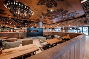 a restaurant with wooden tables and chairs and a bar at RiKu HOTEL Göppingen in Göppingen