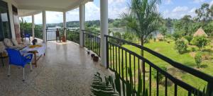 a balcony of a house with two dogs on it at Nile Retreat in Jinja