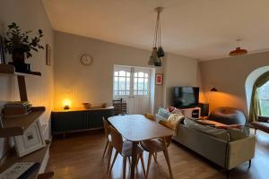 a living room with a couch and a table at Peaceful bright city hide away with parking in London