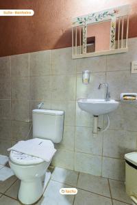 a bathroom with a toilet and a sink at Pousada Le Monte Cristo c/ Café Guaramiranga in Guaramiranga