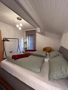 1 dormitorio con 2 camas con almohadas rojas. en Fridas Place - DER Blick über ganz Villach - 160 m2 Familienoase, en Villach