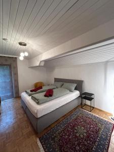 a bedroom with a large bed with a rug at Fridas Place - DER Blick über ganz Villach - 160 m2 Familienoase in Villach
