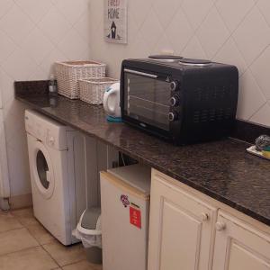 a microwave sitting on a counter in a kitchen at Altos H in Santiago del Estero