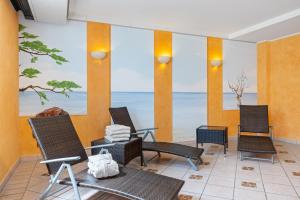 a room with chairs and a view of the ocean at Seehof Seehof 102 in Bansin +1 photo