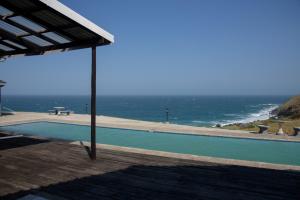 a swimming pool with a view of the ocean at Green Fields Hotel, Coffee Bay in Coffee Bay