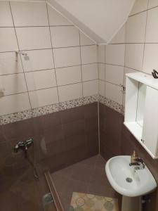 a bathroom with a sink and a shower at Apartman Vid in Soko Banja +12 photos