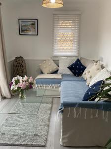 1 dormitorio con 2 camas y un jarrón de flores en Leeward Lodge, en Totland
