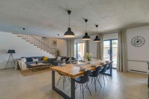 a dining room and living room with a table and chairs at Modern villa Amoroso with pool in Porec in Nova Vas