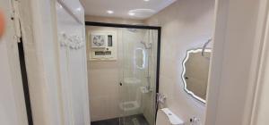 a bathroom with a shower and a glass shower backdoor at Socota real estate development in Cairo