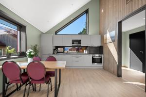 a kitchen with a dining room table and chairs at Kviltorp Camping in Molde