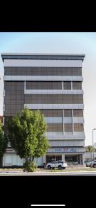 a large building with a car parked in front of it at لوريت للشقق المخدومة in Jeddah