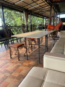 a large table and chairs on a patio at La Villa in Kok-Shoky