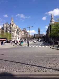 a busy city street with people crossing the street at Residencial clérigos ROOM 3 in Porto