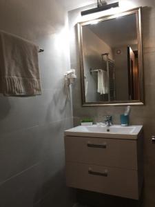 y baño con lavabo y espejo. en Apartment Queen Bridge en Sibiu