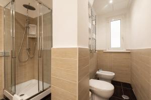 a bathroom with a toilet and a shower at Fleming Suites in Rome