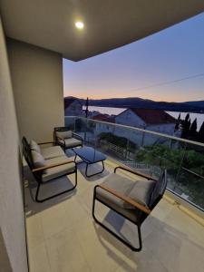 a balcony with couches and a view of the water at Apartments Filipo in Trogir