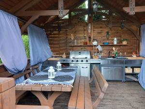 an outdoor kitchen with a table and a stove at Pokoje Gościnne Magnolia Rooms in Serock
