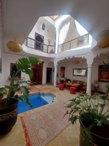 a large room with a swimming pool in a house at Riad Sophora - Peaceful Heaven in Marrakech in Marrakesh