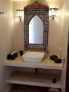 a bathroom with a sink and a mirror on a counter at Riad Sophora - Peaceful Heaven in Marrakech in Marrakesh